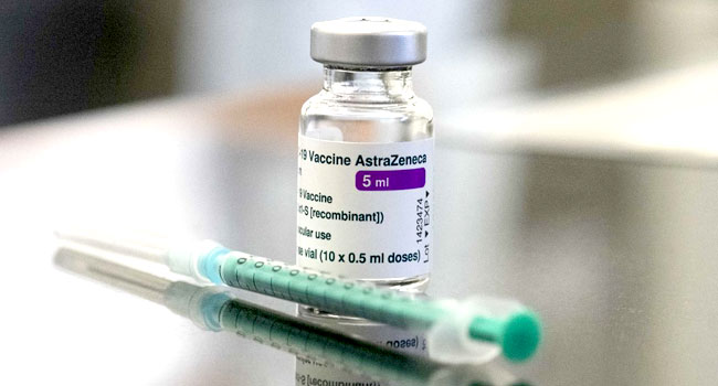 In this file photo, a vial containing the COVID-19 vaccine by AstraZeneca and a syringe are seen on a table. AFP