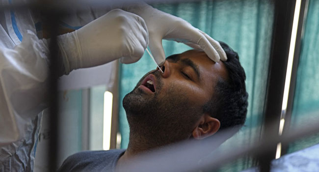 A health worker collects a nasal swab sample from a man to test for the Covid-19 coronavirus in Amritsar on April 18, 2021. Narinder NANU / AFP